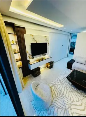 a living room with a television and a couch at Chic studio Casablanca in Casablanca