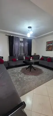 a living room with couches and a table at appartement a louer sable d'or mansouria in Pont Blondin