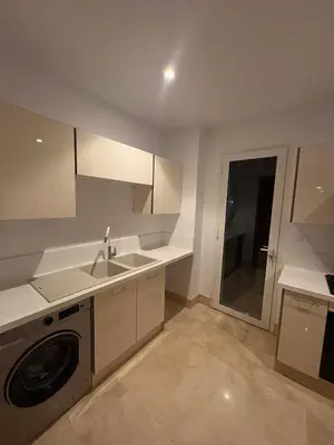 a kitchen with a sink and a washing machine at Smile City Homes in Casablanca