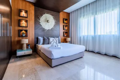 a bedroom with a large bed and a large window at Exceptional Penthouse Private Terrace & Pool in Bouznika