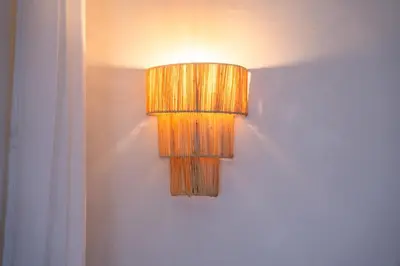 a lamp hanging on a wall in a room at Exceptional Penthouse Private Terrace & Pool in Bouznika