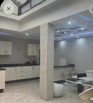 a kitchen with white cabinets and a clock on the ceiling at luxury apartment in casablanca in Maarif