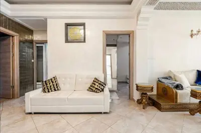 a living room with a white couch and a table at luxury apartment in casablanca in Maarif