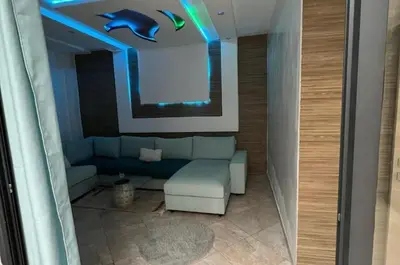 a living room with a couch and blue lights at luxury apartment in casablanca in Maarif