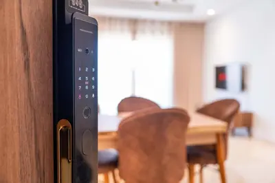 a close up of a remote control in front of a table at Cozy Studio with Pool & Parking in Aïn Harrouda