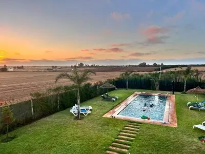 a swimming pool in the middle of a yard at Ferme royale Bensliman in O Ben Slimane