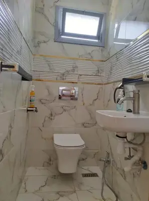 a bathroom with a toilet and a sink at Ferme royale Bensliman in O Ben Slimane