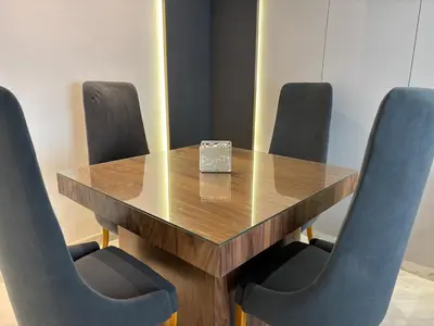a wooden table with four chairs and a box on it at Corniche Casablanca - Kimberly Luxury Suite in Casablanca