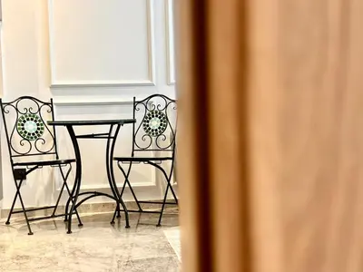 a table and two chairs in a room at Spacious, Quiet Apartment with Parking , Fiber in Casablanca