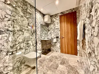 a bathroom with a toilet and a glass shower at Spacious, Quiet Apartment with Parking , Fiber in Casablanca