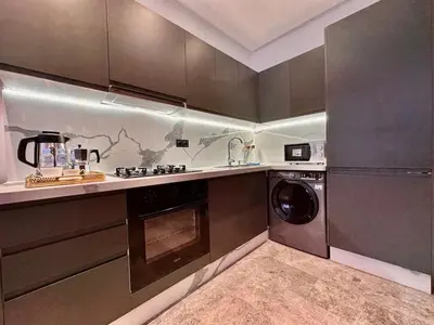 a kitchen with a washer and a dishwasher in it at Calm Studio in Oasis, Near Train Station in Casablanca