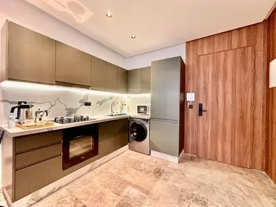 a kitchen with a washer and dryer in it at Calm Studio in Oasis, Near Train Station in Casablanca