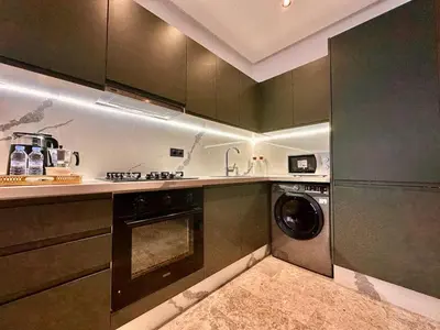 a kitchen with a washer and a dishwasher at Calm Studio in Oasis, Near Train Station in Casablanca