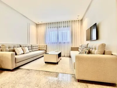 a living room with two couches and a tv at Cozy, Elegant Apartment, Parking and Fiber in Casablanca