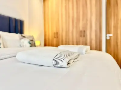 two white towels are sitting on top of a bed at Cozy, Elegant Apartment, Parking and Fiber in Casablanca