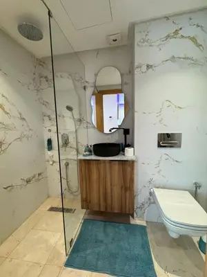 a bathroom with a shower and a toilet and a mirror at Modern Studio France ville in Casablanca