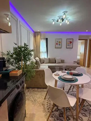a living room with a table and a couch at Modern Studio France ville in Casablanca