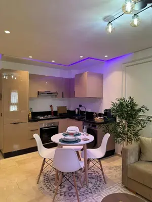 a kitchen and living room with a table and chairs at Modern Studio France ville in Casablanca
