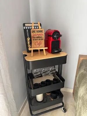 a shelf with a wine burner and a box on it at Studio Zenata Central Park Près de la plage Vue Piscine in Aïn Harrouda