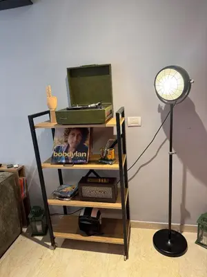 a book shelf with a laptop and a lamp at Studio Zenata Central Park Près de la plage Vue Piscine in Aïn Harrouda