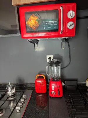 a red blender sitting on top of a kitchen counter at Studio Zenata Central Park Près de la plage Vue Piscine in Aïn Harrouda