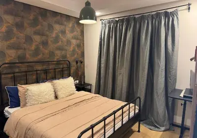 a bedroom with a bed and a large window at Studio Zenata Central Park Près de la plage Vue Piscine in Aïn Harrouda