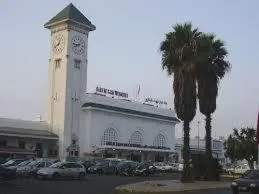 a building with a clock tower in a parking lot at Appartement Familial Emile Zola in Casablanca