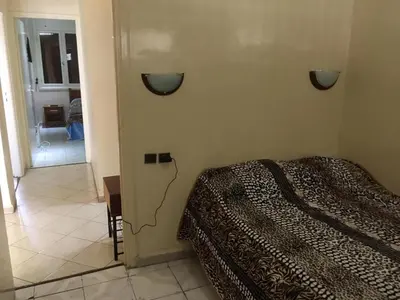 a bedroom with a bed and a room with a hallway at Appartement Familial Emile Zola in Casablanca