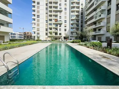 an empty swimming pool in a apartment building at Modern Apartment Pool Balcony & Comfort in Aïn Harrouda