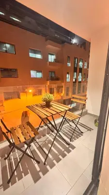 a table and chairs on a balcony with a building at Castilo in Casablanca