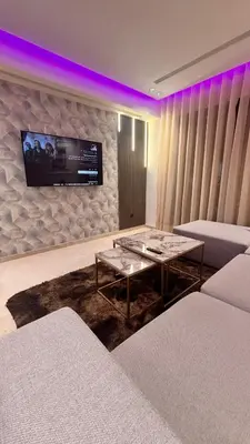 a living room with a table and a tv on the wall at Castilo in Casablanca