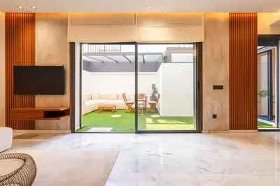 an open living room with a sliding glass door at MAYA SUITES - Corniche Seaside in Casablanca