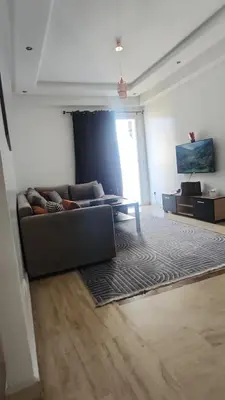 a living room with a couch and a table at Studio maarif 75m residense ferme in Casablanca