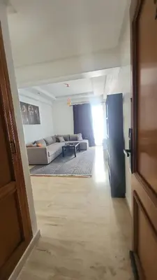 a living room with a couch and a table at Studio maarif 75m residense ferme in Casablanca