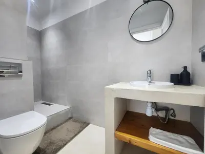 a bathroom with a toilet and a sink and a mirror at The Nineteen Racine by IB Signature - Stylish two-Bedroom flat - Wifi, Self Check-in, Day and Night Security, Terrace, free parking, close to all amenities in Casablanca