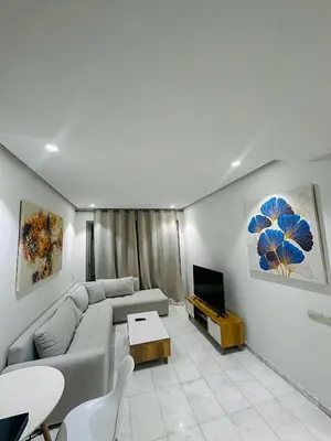 a living room with a couch and a tv at Studio de luxe, lumineux et parfait in Casablanca