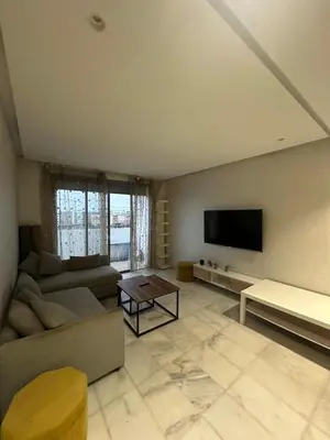 a living room with a couch and a tv at Studio de luxe, lumineux et parfait in Casablanca