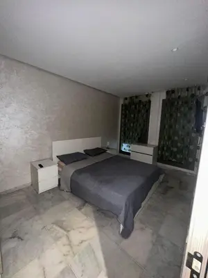 a bedroom with a bed and two night stands at Studio de luxe, lumineux et parfait in Casablanca