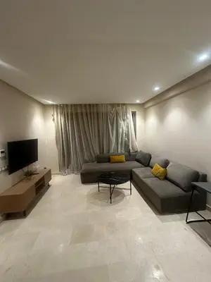 a living room with a couch and a flat screen tv at Studio de luxe, lumineux et parfait in Casablanca