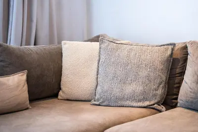 a couch with several pillows on it at C07- Pestana - Luxury Hotel Flat - Terrace - Pool in Casablanca