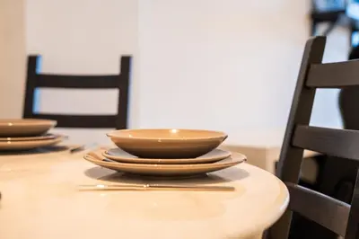 a wooden table with bowls on top of it at C07- Pestana - Luxury Hotel Flat - Terrace - Pool in Casablanca