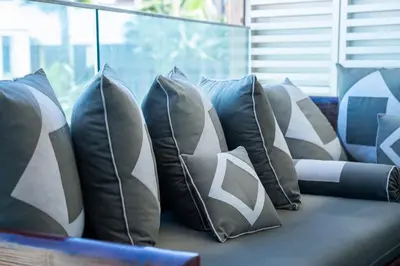 a bunch of pillows sitting on a couch at C07- Pestana - Luxury Hotel Flat - Terrace - Pool in Casablanca