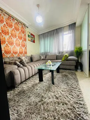 a living room with a couch and a table at Résidence in Casablanca