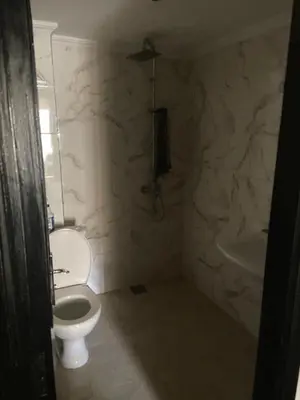 a bathroom with a white toilet and a tub at Résidence in Casablanca