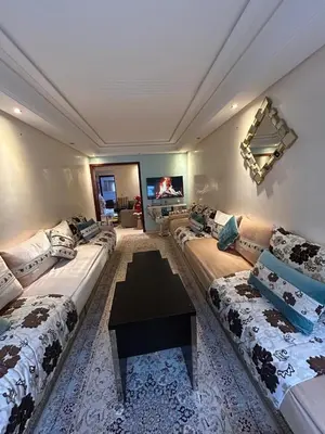 a living room with two couches and a table at Appartement à agdal 2 chambres in Rabat