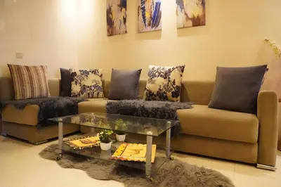a living room with a couch and a table at Appartement à agdal 2 chambres in Rabat