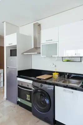 a kitchen with a washer and a washing machine at Charming Modern Studio near Corniche Mohammedia in Mohammedia