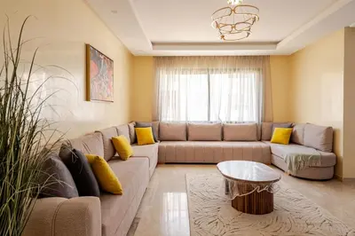 a living room with a couch and a table at Seaside 3 bedrooms apartment in Mansouria near Sablette Beach Mohammadia in Pont Blondin