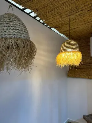 two chandeliers hanging from the ceiling in a room at Les Flots Blancs - Appartement détente et bonheur côté mer in Bouznika