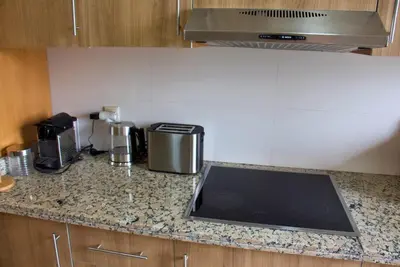 a kitchen with a counter top with a stove and appliances at Elegant & Chic 2 Bedrooms - Maarif in Casablanca